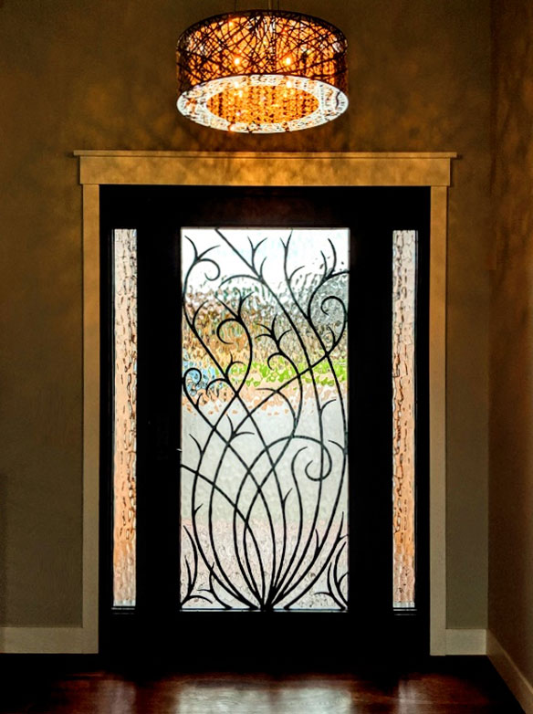 Custom contemporary stylistic grasses, single iron door entry with sidelights, Flemish glass, patented Thermal Break, Hand Rubbed Bronze finish