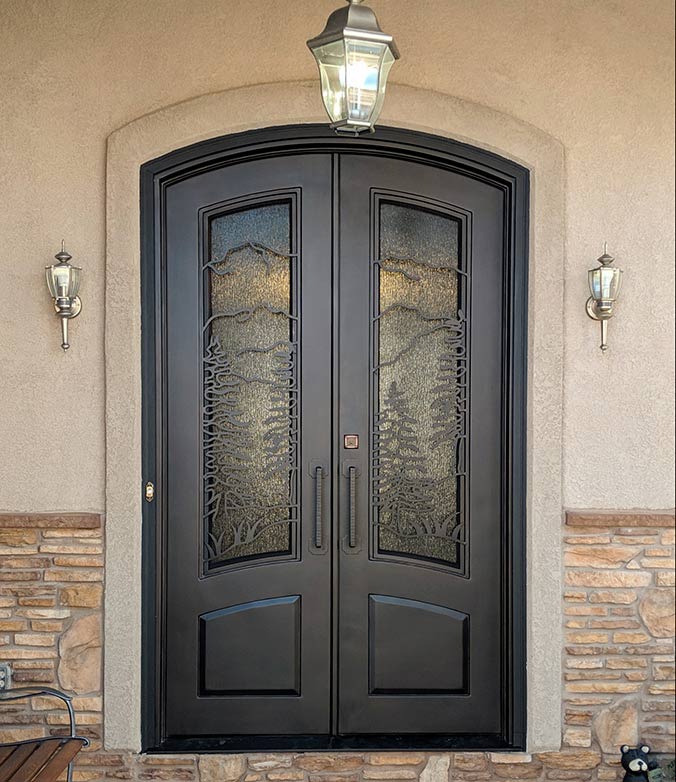 Custom Iron entry with landscape scene of Pikes Peak and pine trees, Cotswald glass, Patented Thermal Break, Antique Bronze finish