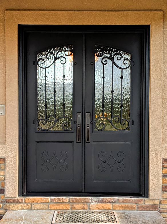 Site photo of custom iron entry, Spanish style, Flemish glass, Patented Thermal Break, Hand Rubbed Bronze finish