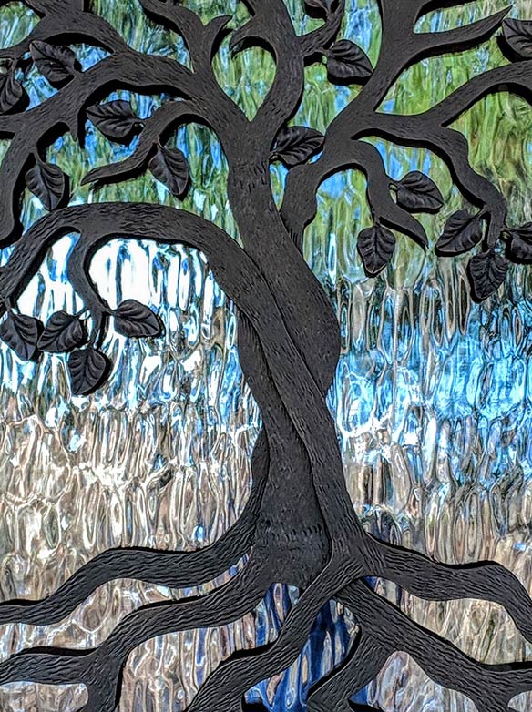 Custom design single door iron entry with a layered Tree of Life iron grill, Flemish glass, Patented Thermal Break, Hand Rubbed Bronze finish