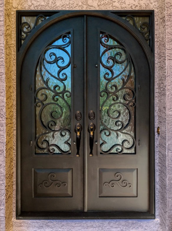 Close-up of Tree of Life Iron Grill showing textured 3 layered twisted trunk with hand cast iron leaves, Flemish glass and Hand Rubbed Bronze finish