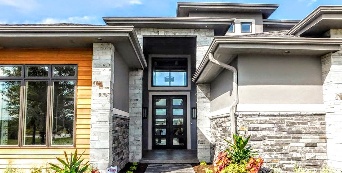 Site photo of home with Apollo design double door iron entry, clear glass, Patented Thermal Break, Hand Rubbed Bronze finish