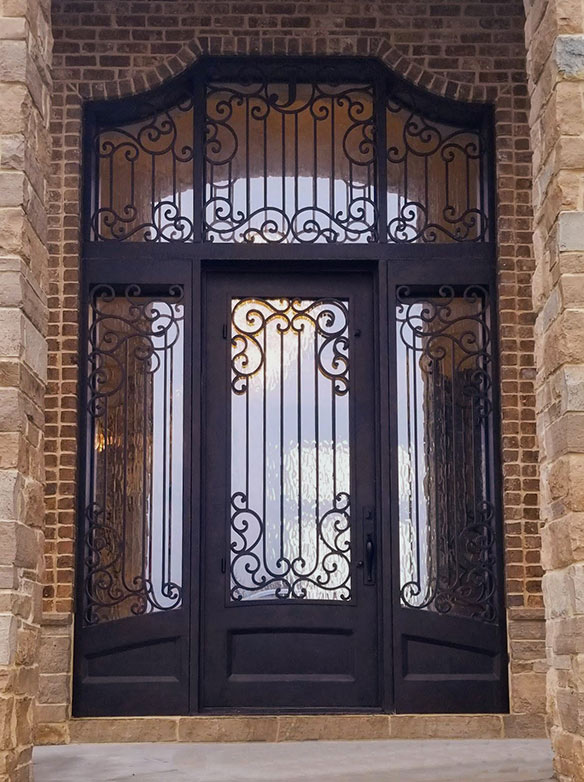 Custom designed French Chateau style iron entry with wide single door, wide sidelights and large matching transom, Flemish glass, Patented Thermal Break, Hand-rubbed Bronze finish