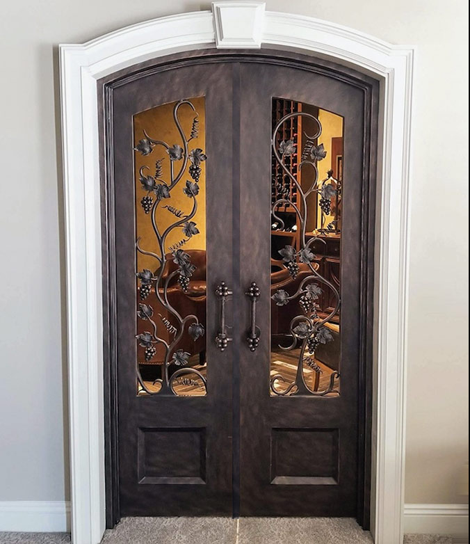 Custom design arch top double door iron Wine Room doors with custom door pulls, grape vine design with cast iron leaves and grapes, Antique Bronze finish, Non-Thermal Break