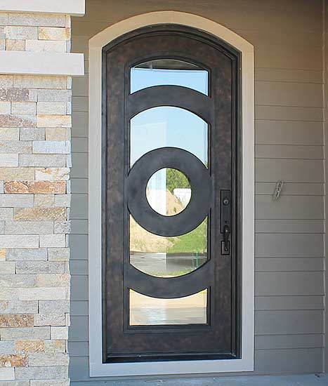 Custom Iron single arched door entry, Patented Thermal Break, contemporary style, hand-rubbed bronze finish, clear glass