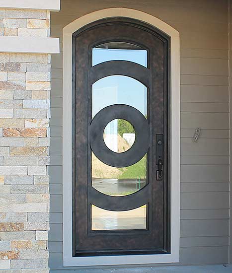 Custom Iron single arched door entry, Patented Thermal Break, contemporary style, hand-rubbed bronze finish, clear glass