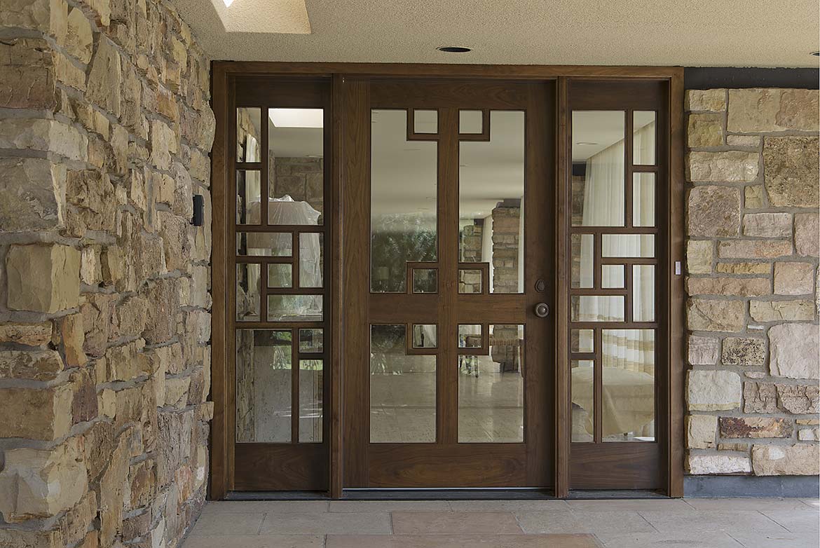 Custom contemporary Walnut entry, geometric design, clear glass panels