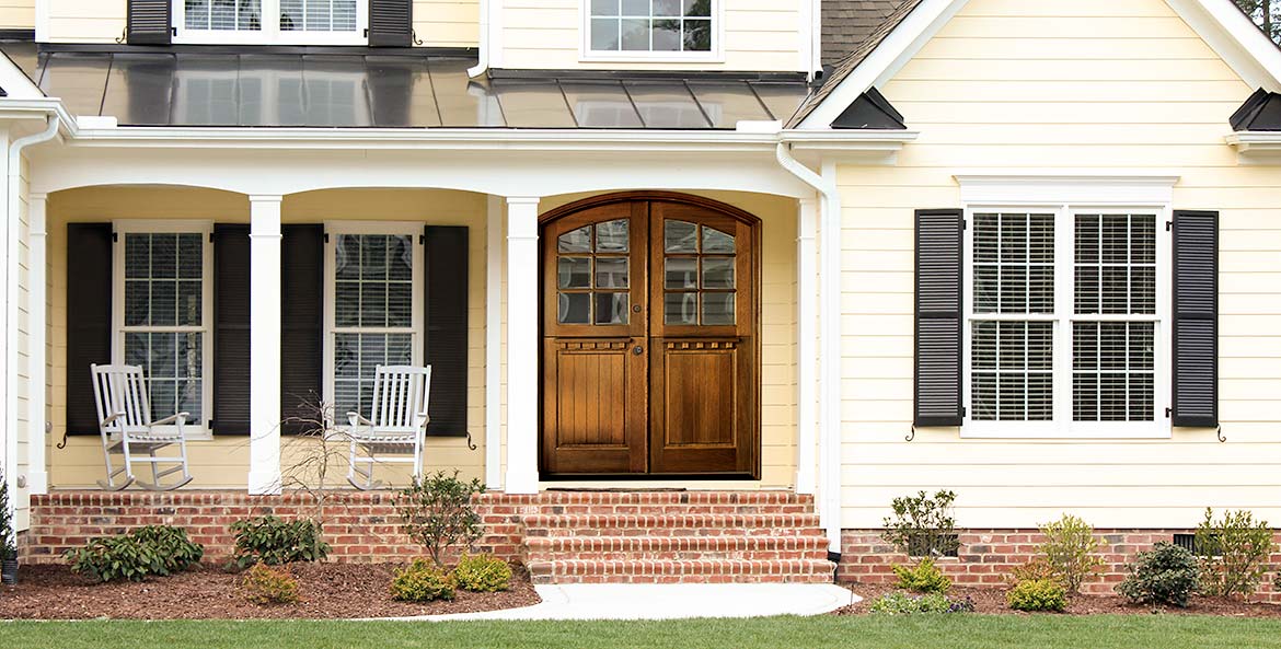 Double entry doors, custom Craftsman style arched top Dutch doors, Mahogany, divided beveled glass panels, raised wood panels