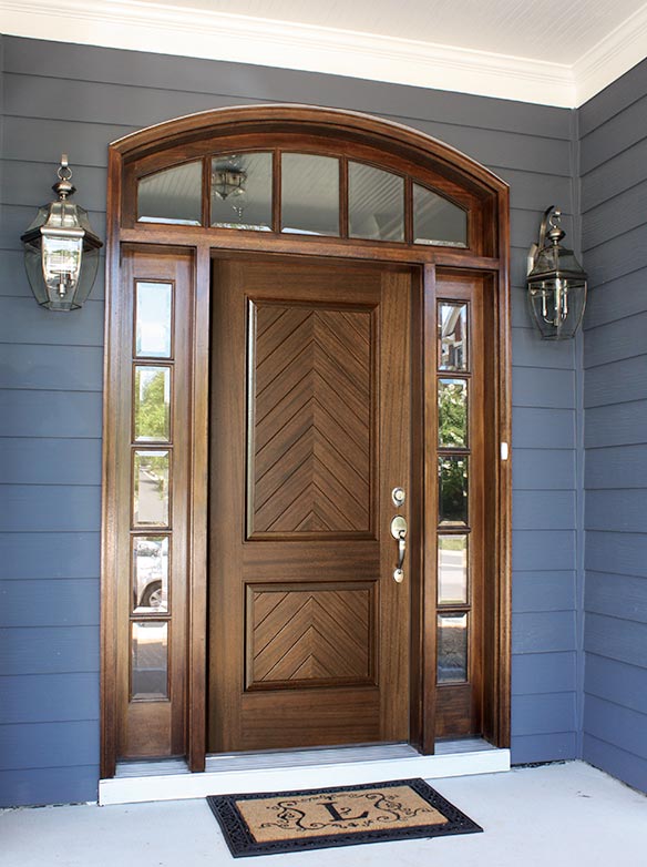 Traditional style single door entry with sidelights and divided lite arched transom, Mahogany, 2 Herringbone wood pattern raised panels, Manchester Collection